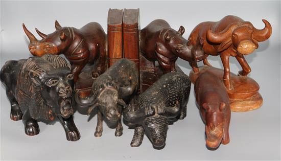 A group of hardwood carvings of rhinos, a lion etc